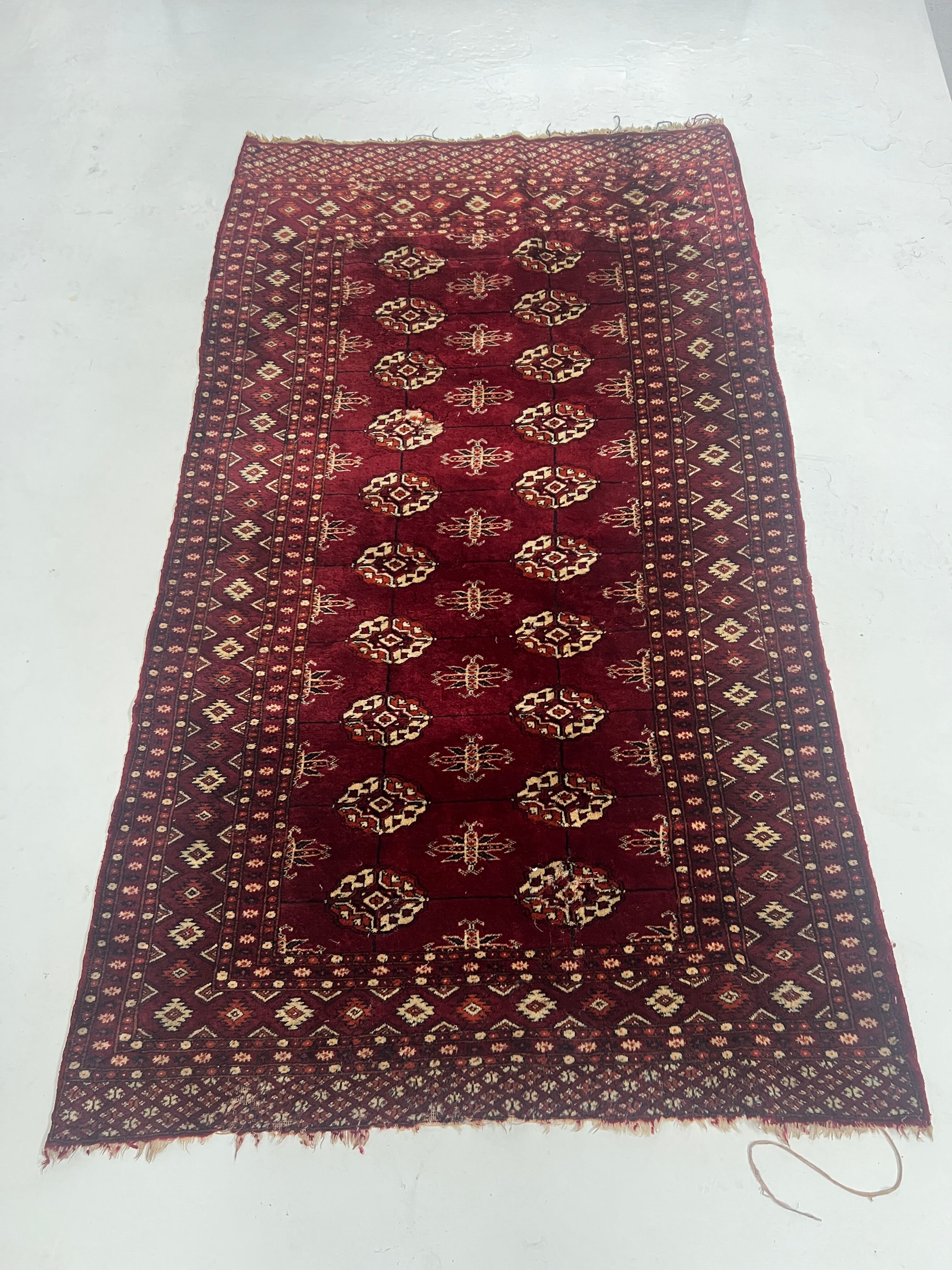 Antique wool rugs with designs on a red background, 20th century.