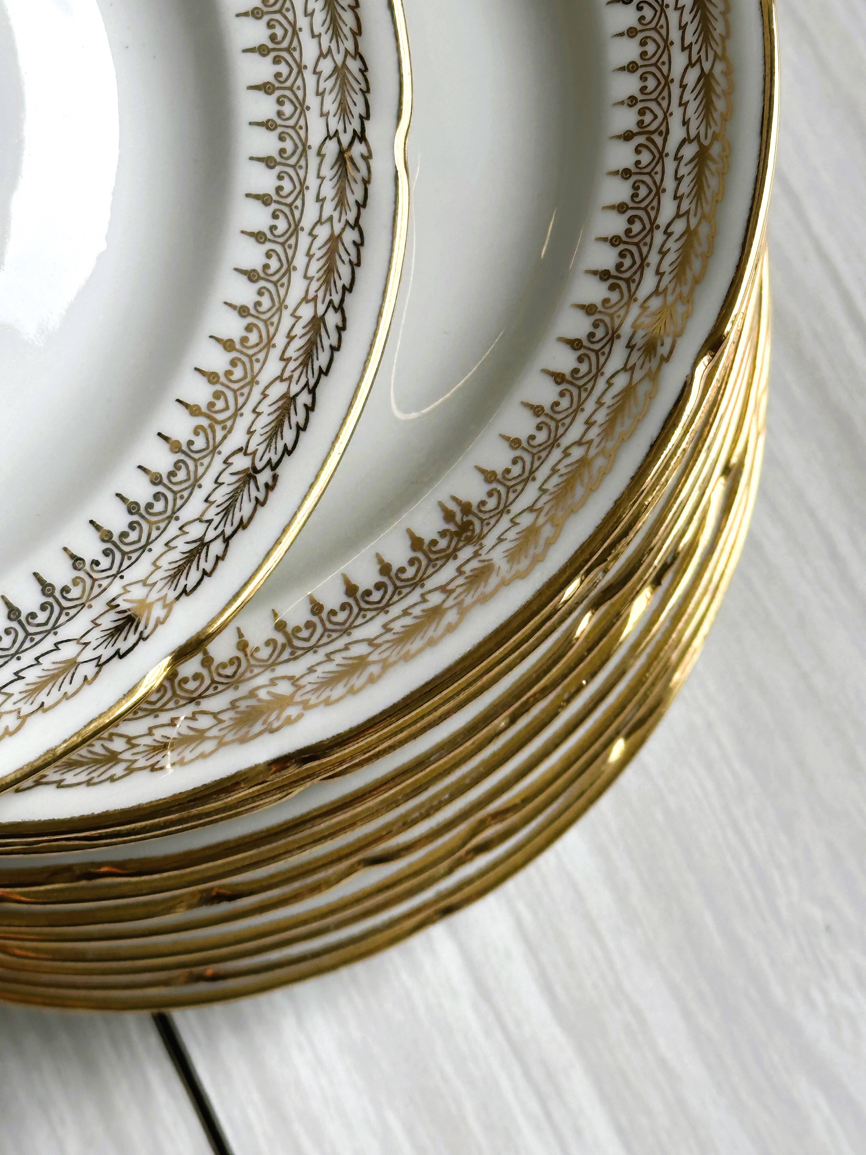 12 Limoges porcelain dessert plates, gold decoration.