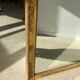Miroir doré style Restauration à décor de palmettes étirées