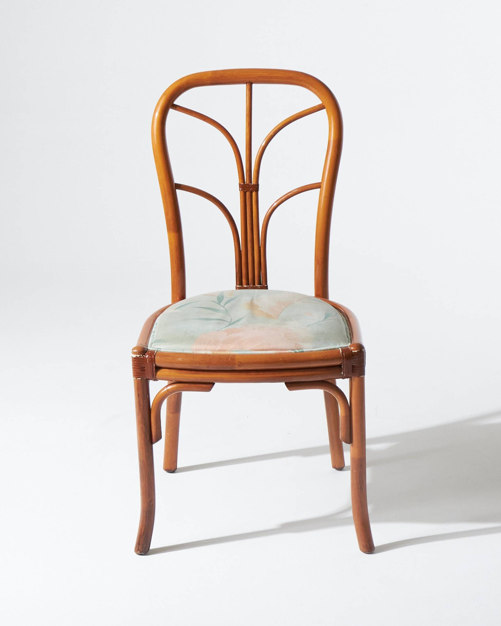 Pair of rattan and blue floral fabric chairs