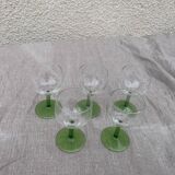 5 transparent glass glasses and green glass vase go