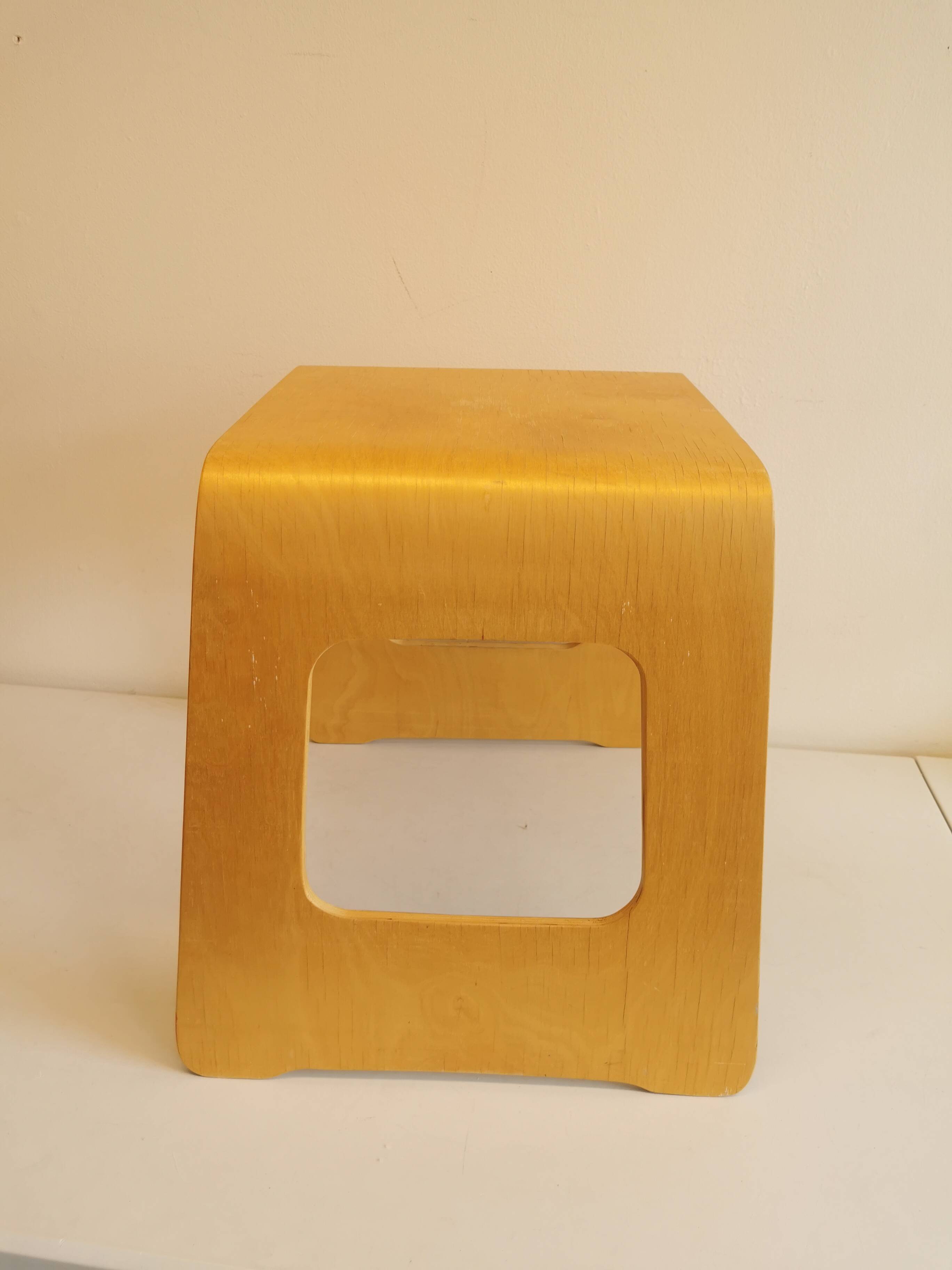 Design stool/side table made of curved plywood.