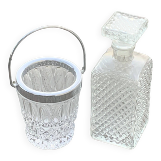 Whiskey carafe and ice bucket in transparent glass and silver-colored metal handle