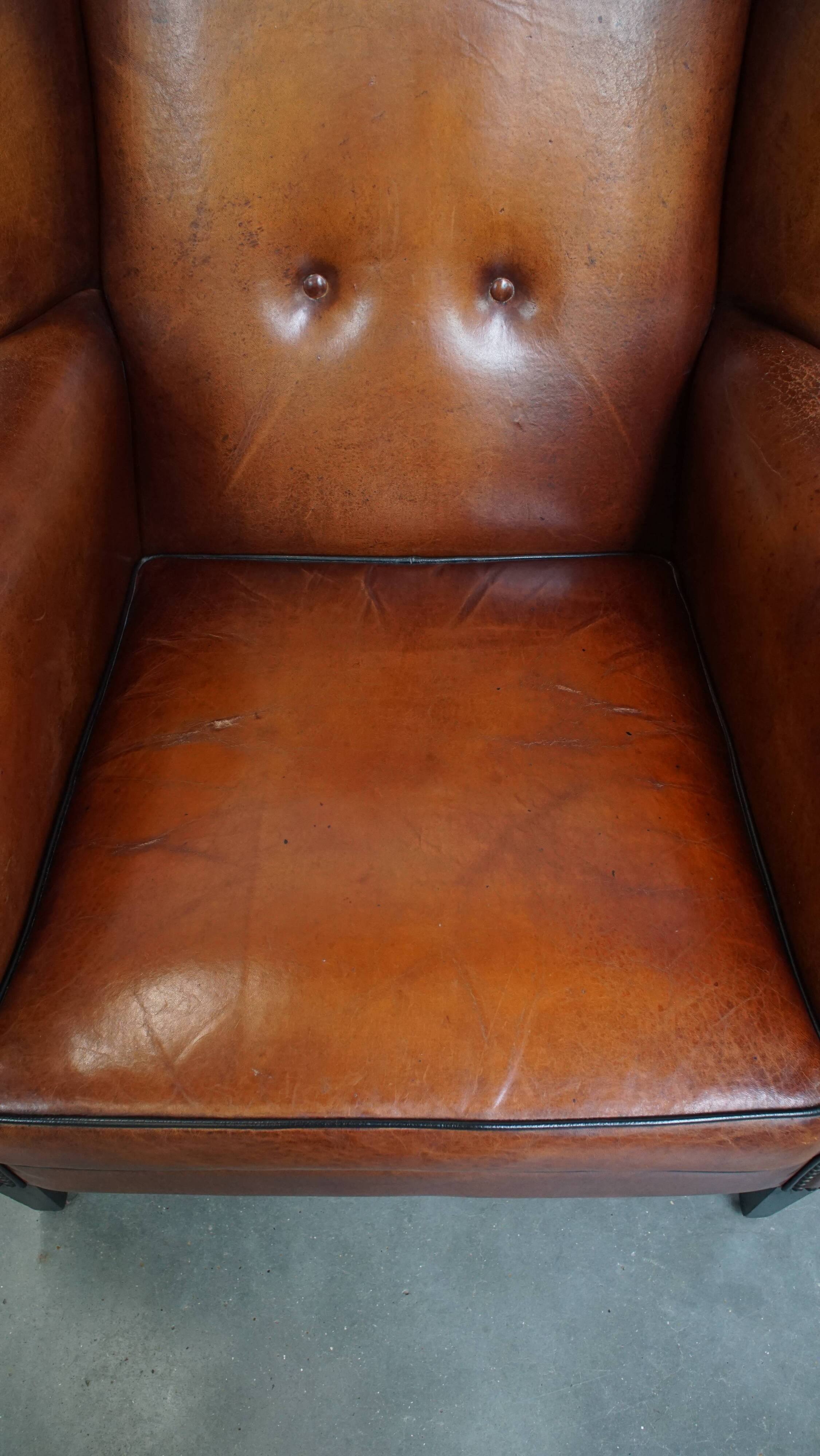 Sheepskin Wingback Chair with Warm Tones and Black Piping