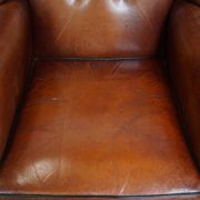 Sheepskin Wingback Chair with Warm Tones and Black Piping