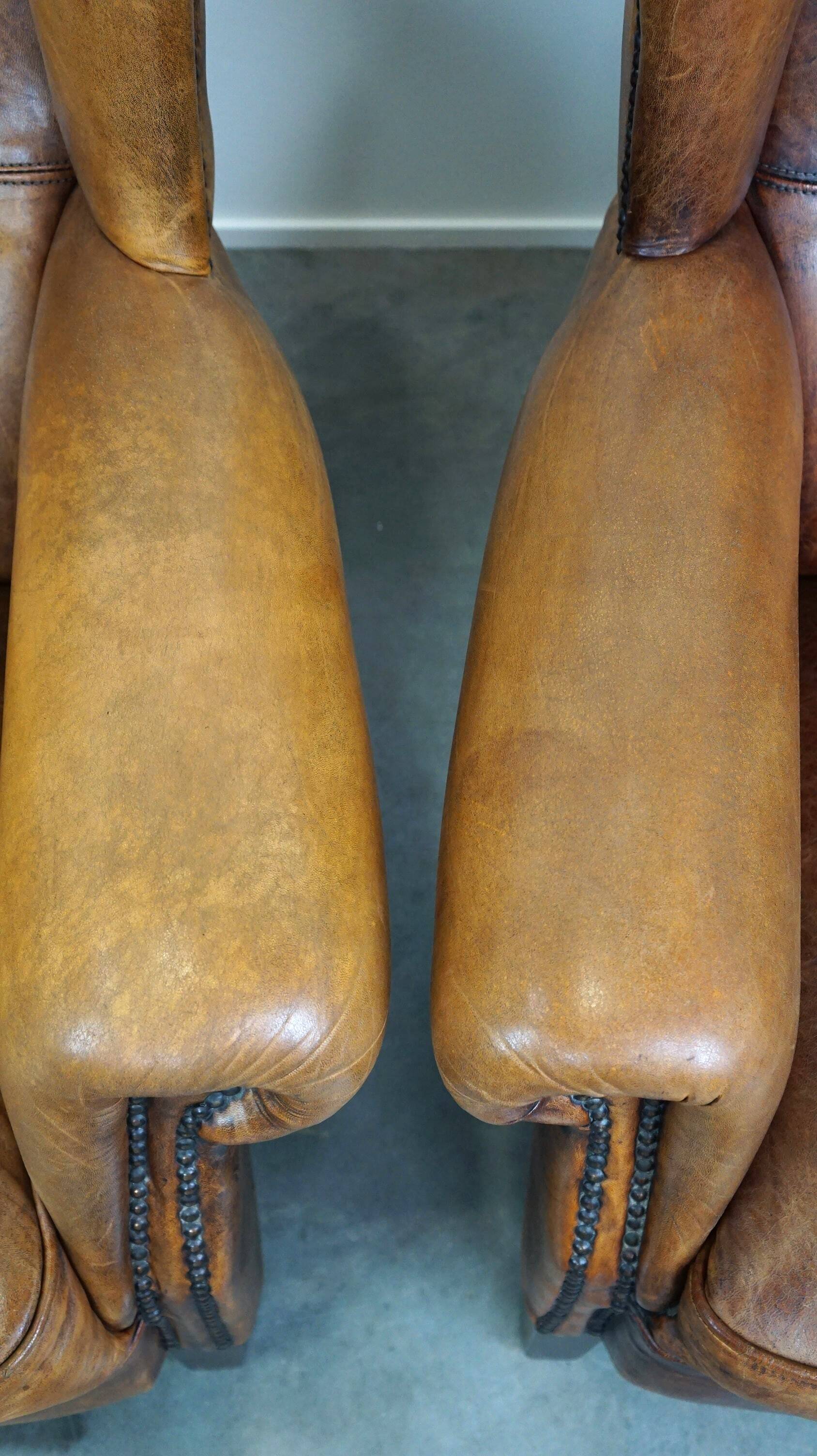 Set of 2 beautiful and correct sheep leather wingback armchairs with fixed seat cushions