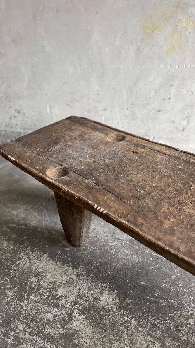 Large antique African bed in dark brown solid wood — sculptural, primitive, low, handcrafted