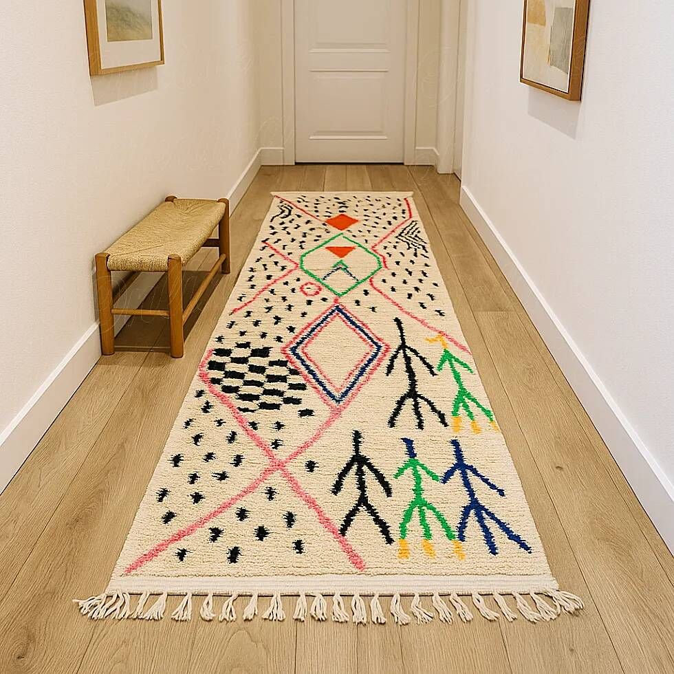 Ecru Azilal rug with colourful Berber symbols.