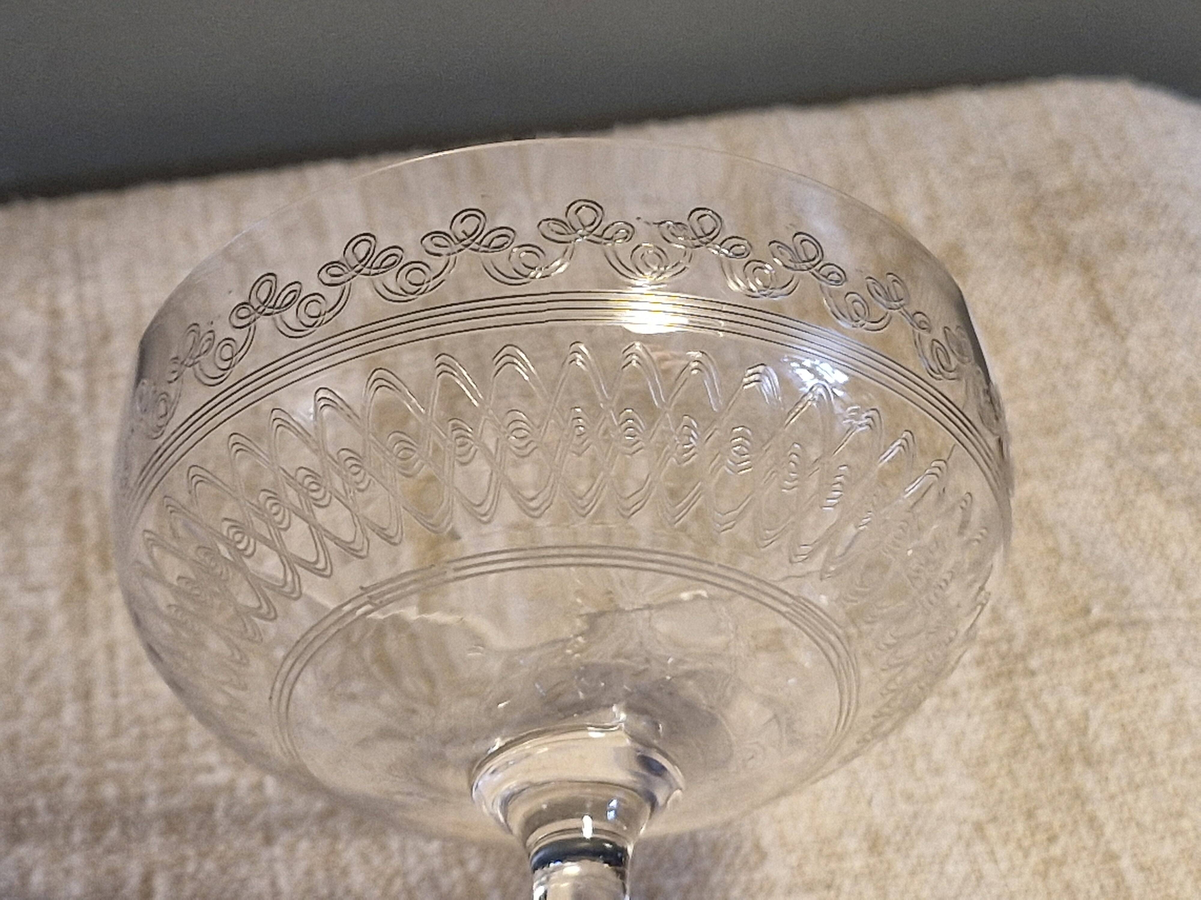 8 antique Baccarat crystal champagne coupes with engraved decoration.
