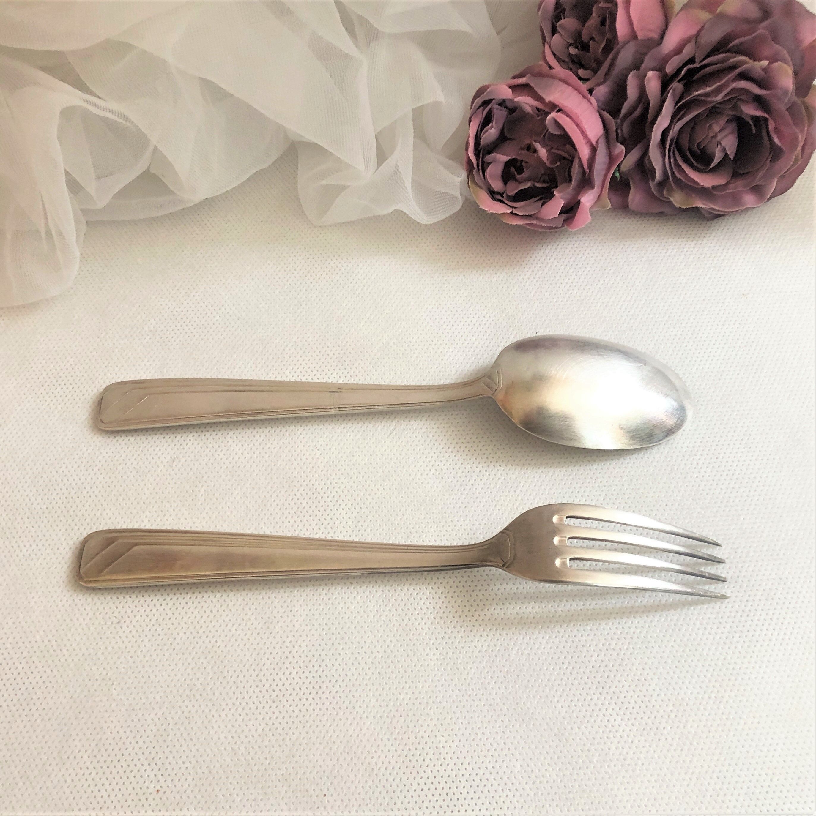 Set of 2 silver metal cutlery with punches