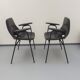 Paire de fauteuils modèle Tonneau, en skaï noir par Pierre Guariche, années 60