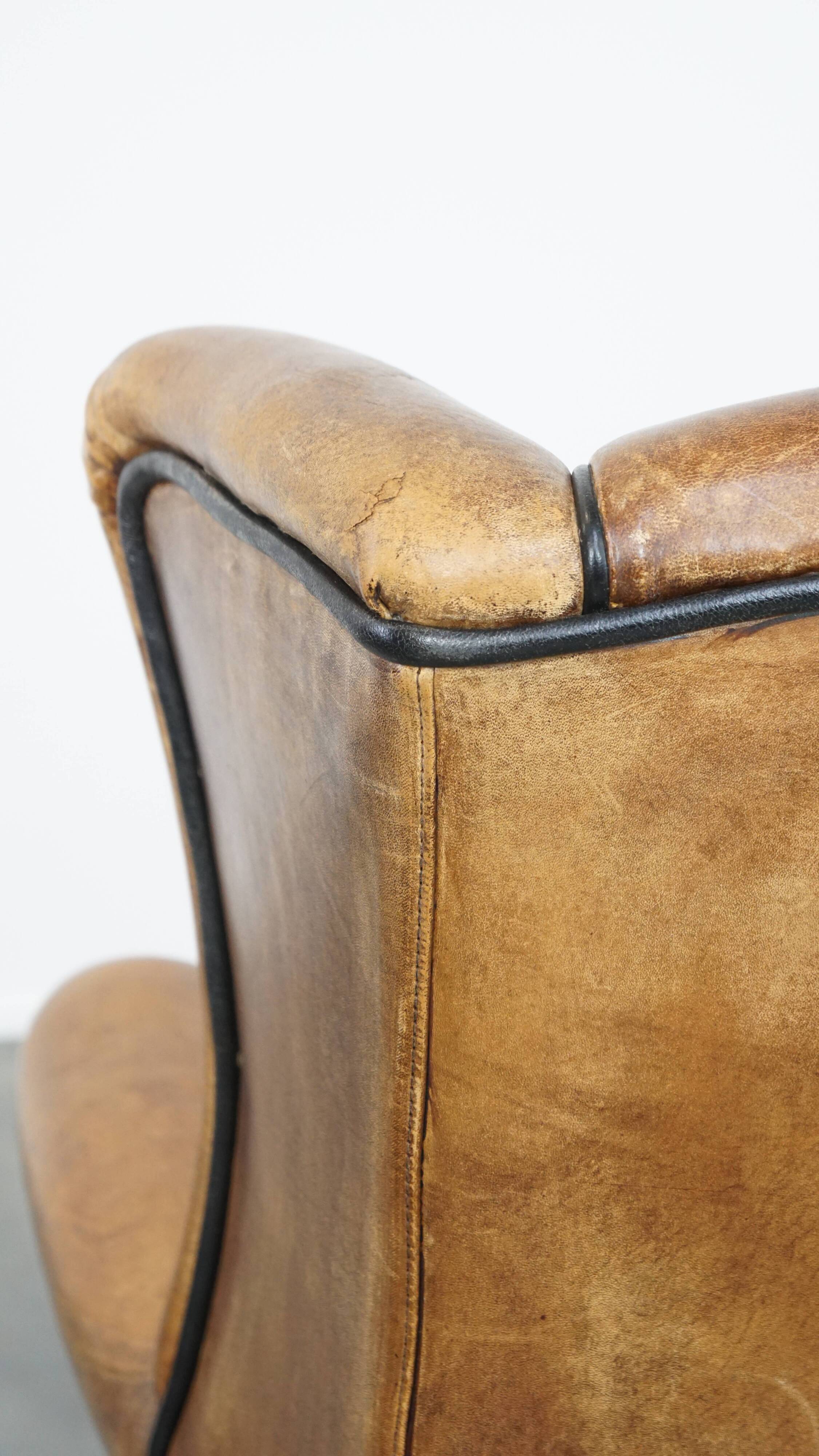 Sheep leather wingback chair finished with black piping