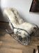 Thonet rocking chair in ivory lacquered bent wood, with a seat in white lambskin.