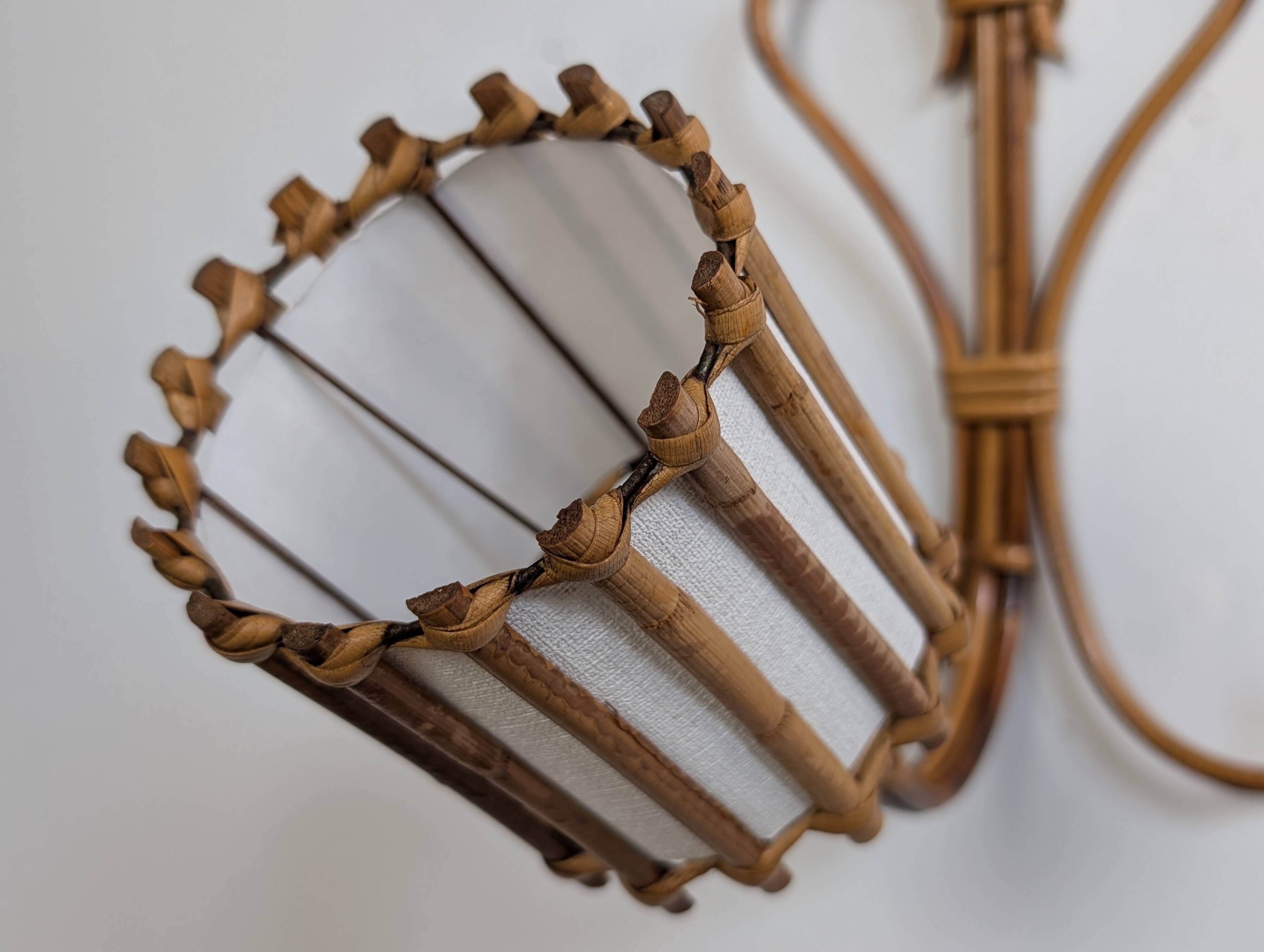 Rattan wall lights by Louis Sognot