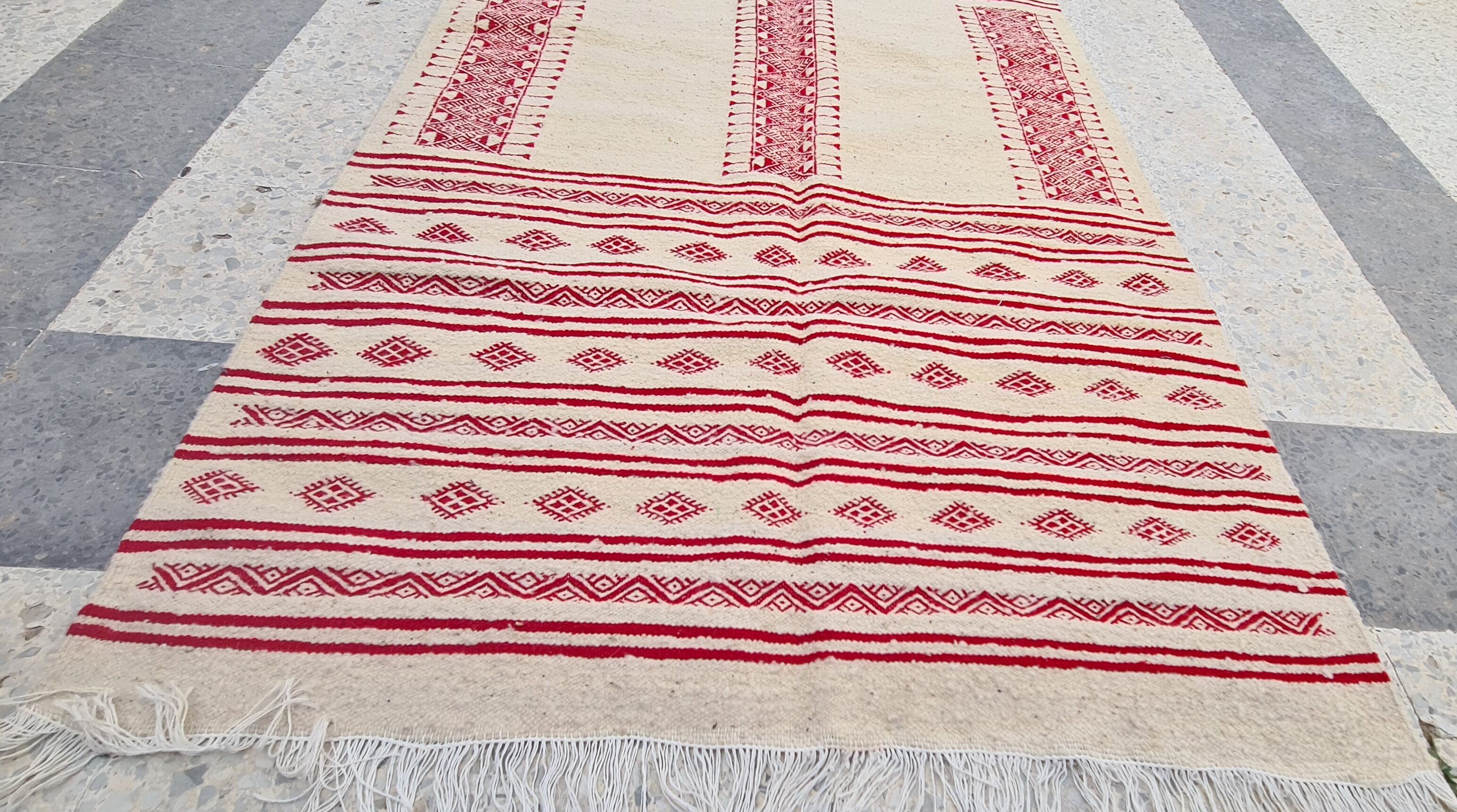 Traditional ethnic-patterned red and white carpet