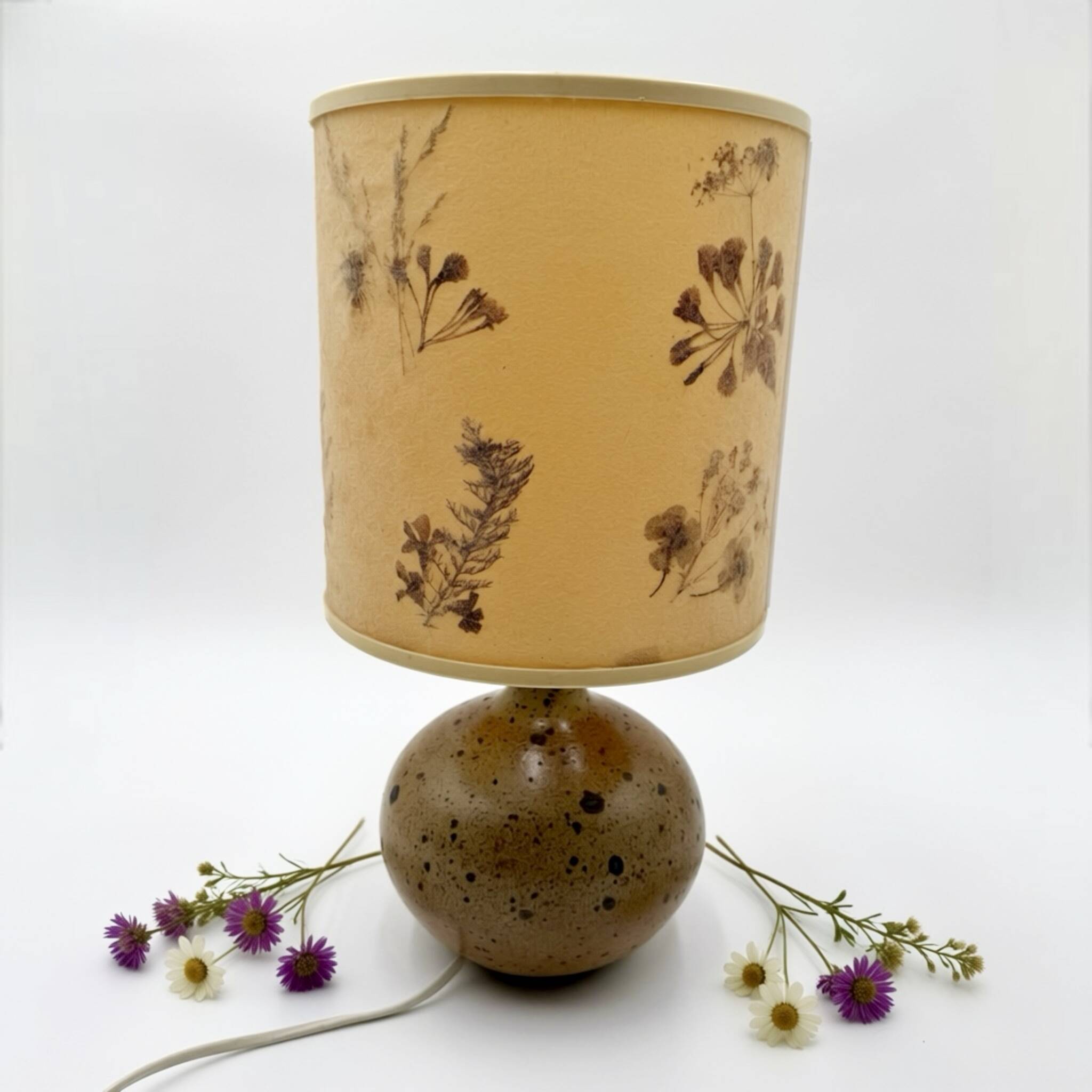 Pyrite stone ball lamp with a lampshade featuring dried flower inclusions.