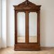 Antique walnut wardrobe with bevelled mirrors.