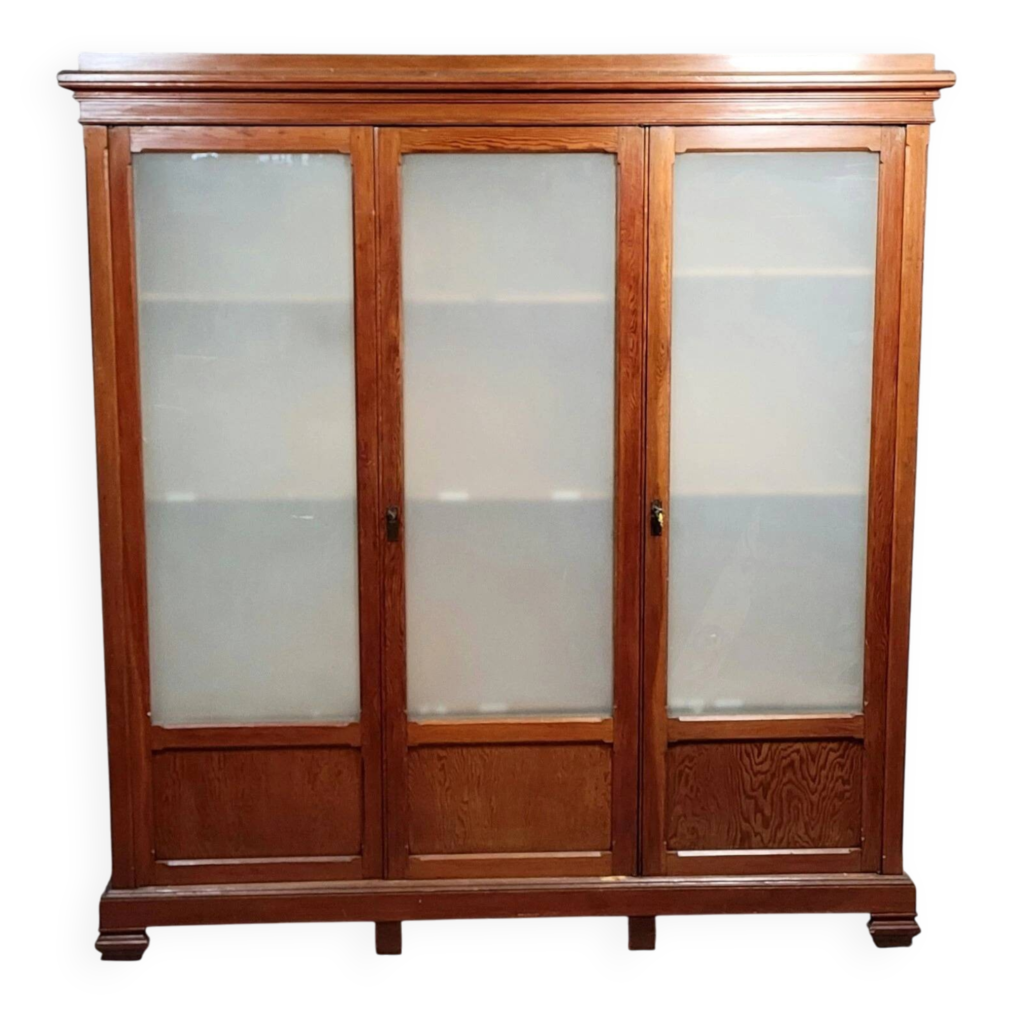 Large pine bookcase with three doors, fitted with frosted glass.