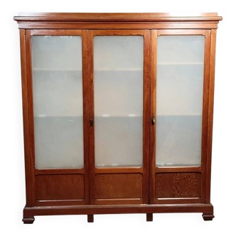Large pine bookcase with three doors, fitted with frosted glass.