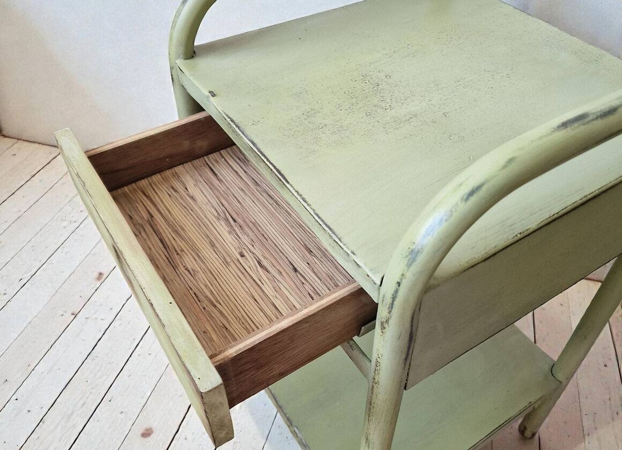 Copy of a pair of patinated metal bedside tables.