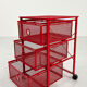 Chest of drawers on red metal wheels, 1980