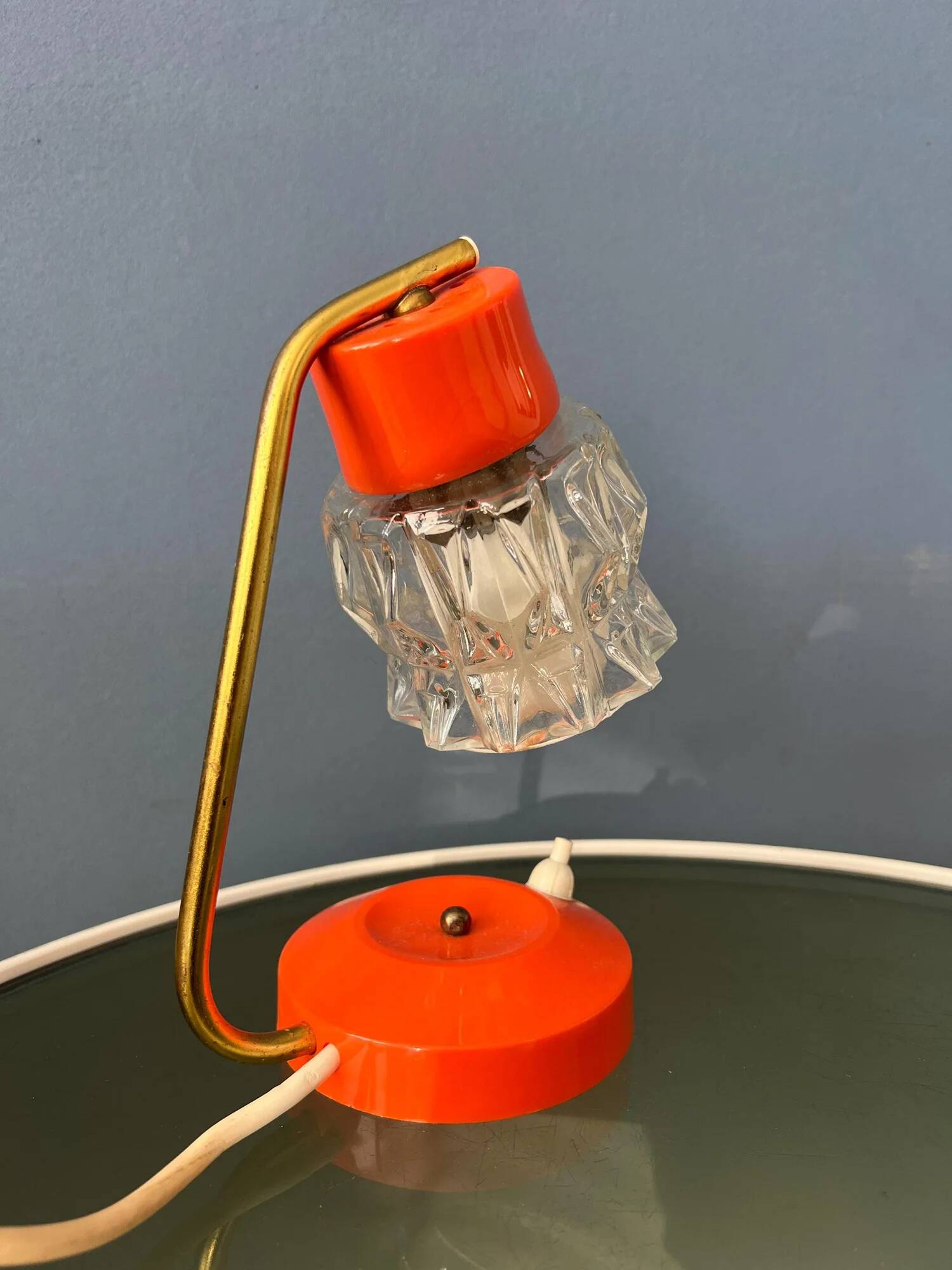 Small orange desk lamp with clear crystal glass shade