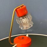 Small orange desk lamp with clear crystal glass shade