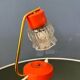 Small orange desk lamp with clear crystal glass shade