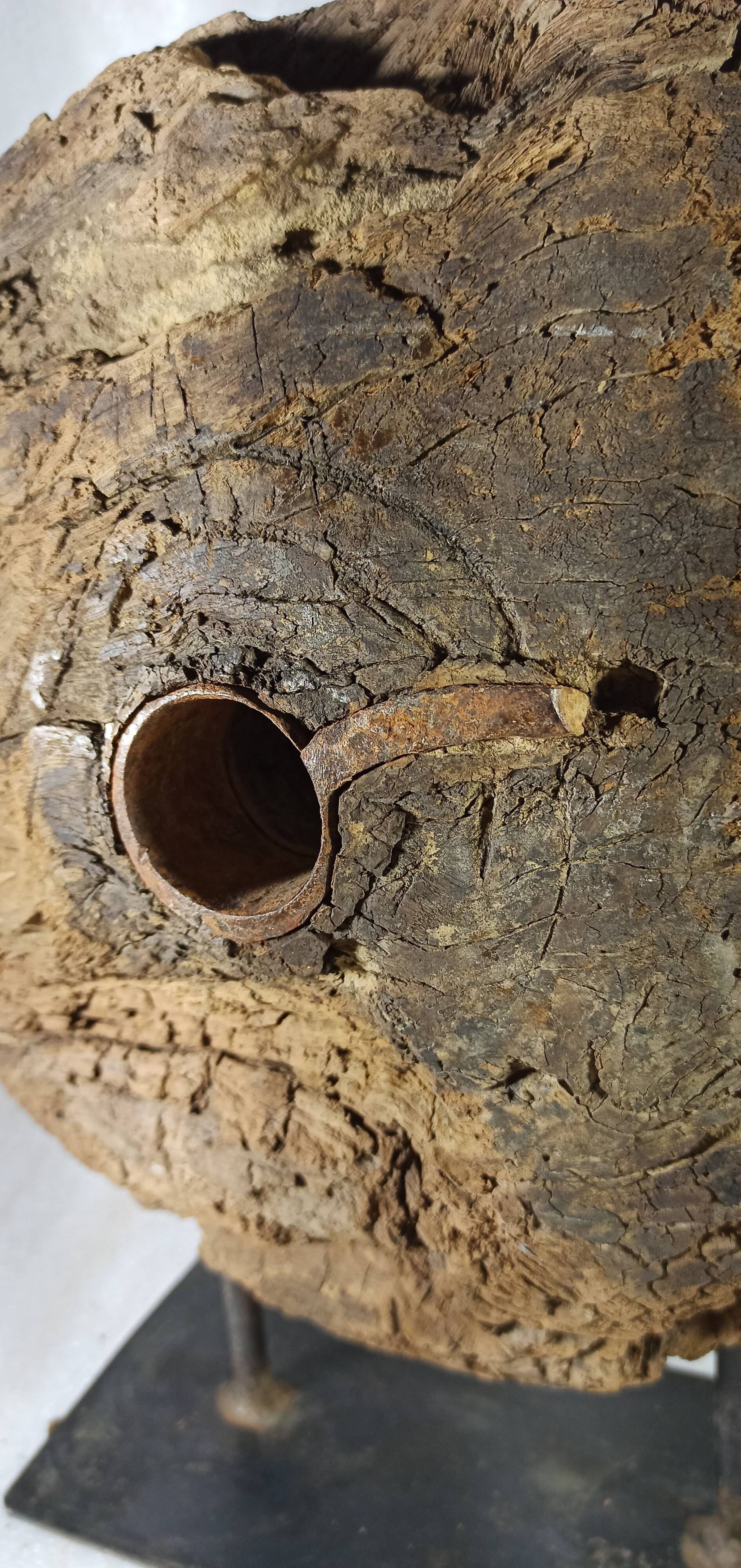 Old wooden pulley wheel on foot