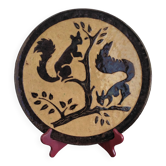 Dauphinois plate in glazed terracotta from the 1950s by Claude Faure, featuring squirrels.