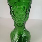 Green glass vase decorated with bunch of grapes and fruits
