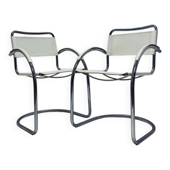 Vintage tubular frame chairs with white skai