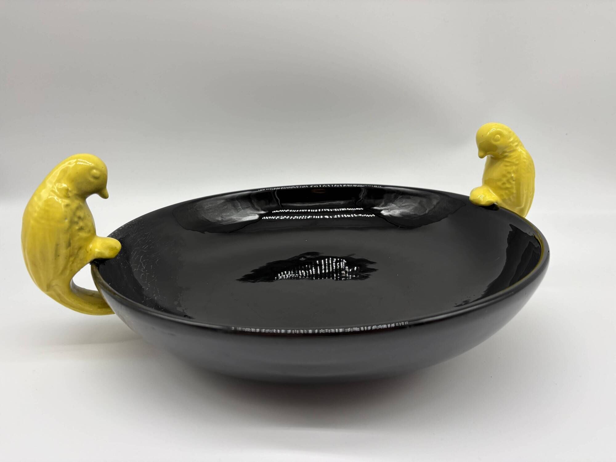 Large vintage black ceramic bowl with yellow parakeets, Vallauris.