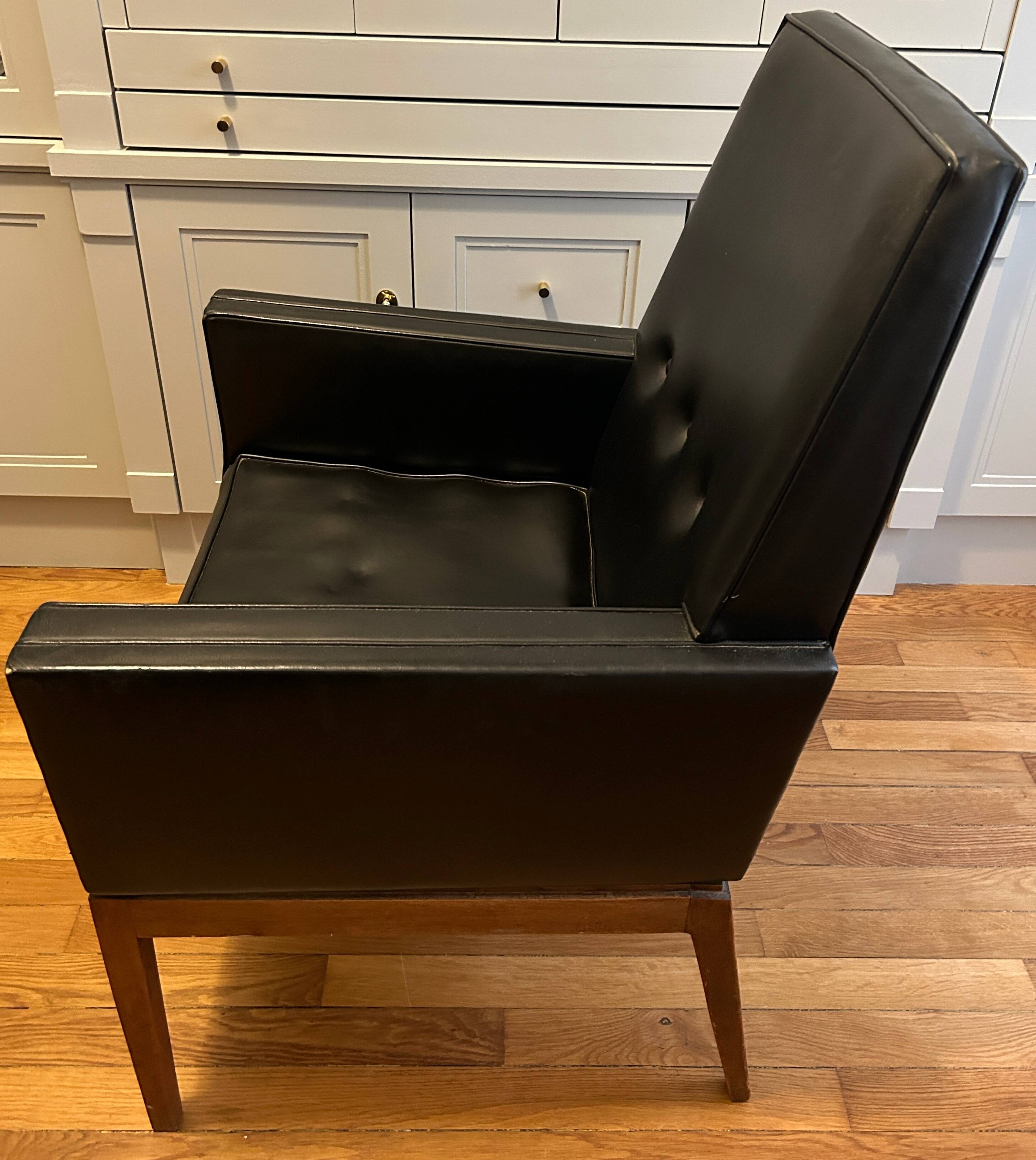 Modernist armchair in wood and black synthetic leather, circa 1960