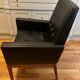 Modernist armchair in wood and black synthetic leather, circa 1960