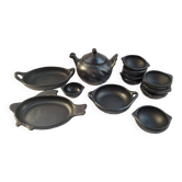 Black terracotta dinnerware set from La Chamba in Colombia. Set of 13 pieces.