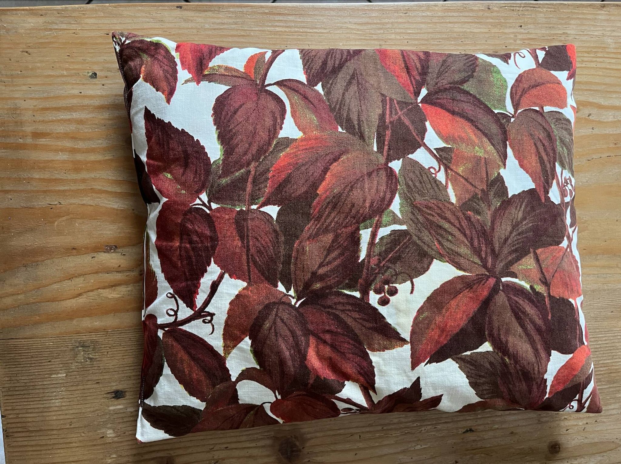 Vintage cushion with virgin vine leaf pattern.