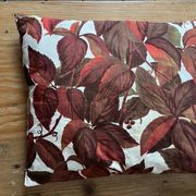 Vintage cushion with virgin vine leaf pattern.