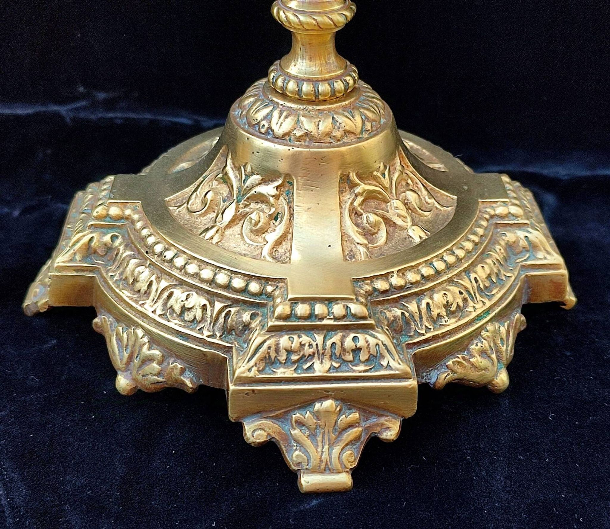 Pair of antique carved bronze candlesticks.