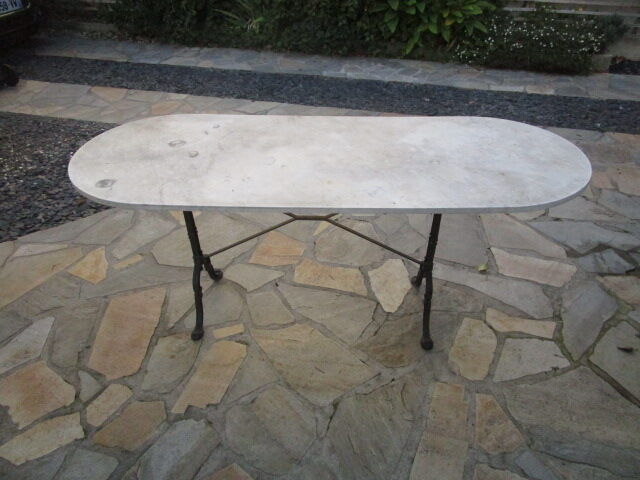 Old bistro table in marble and godin cast iron foot