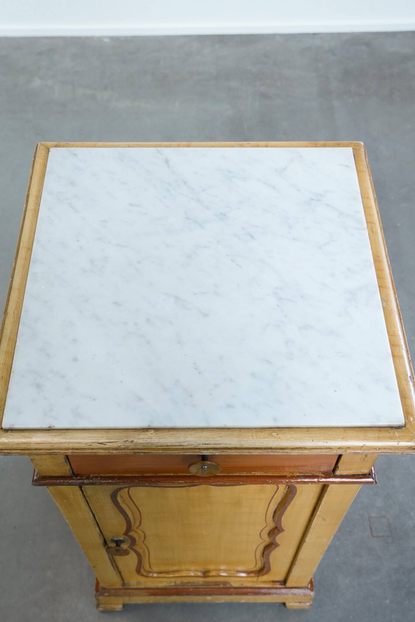 Antique wooden 1-door hallway/nightstand with a light marble top