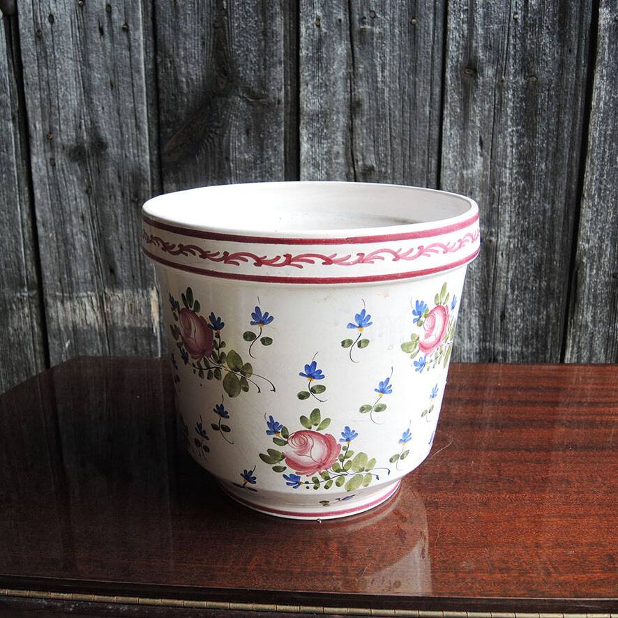 Vintage ceramic pot with hand-painted floral decoration.