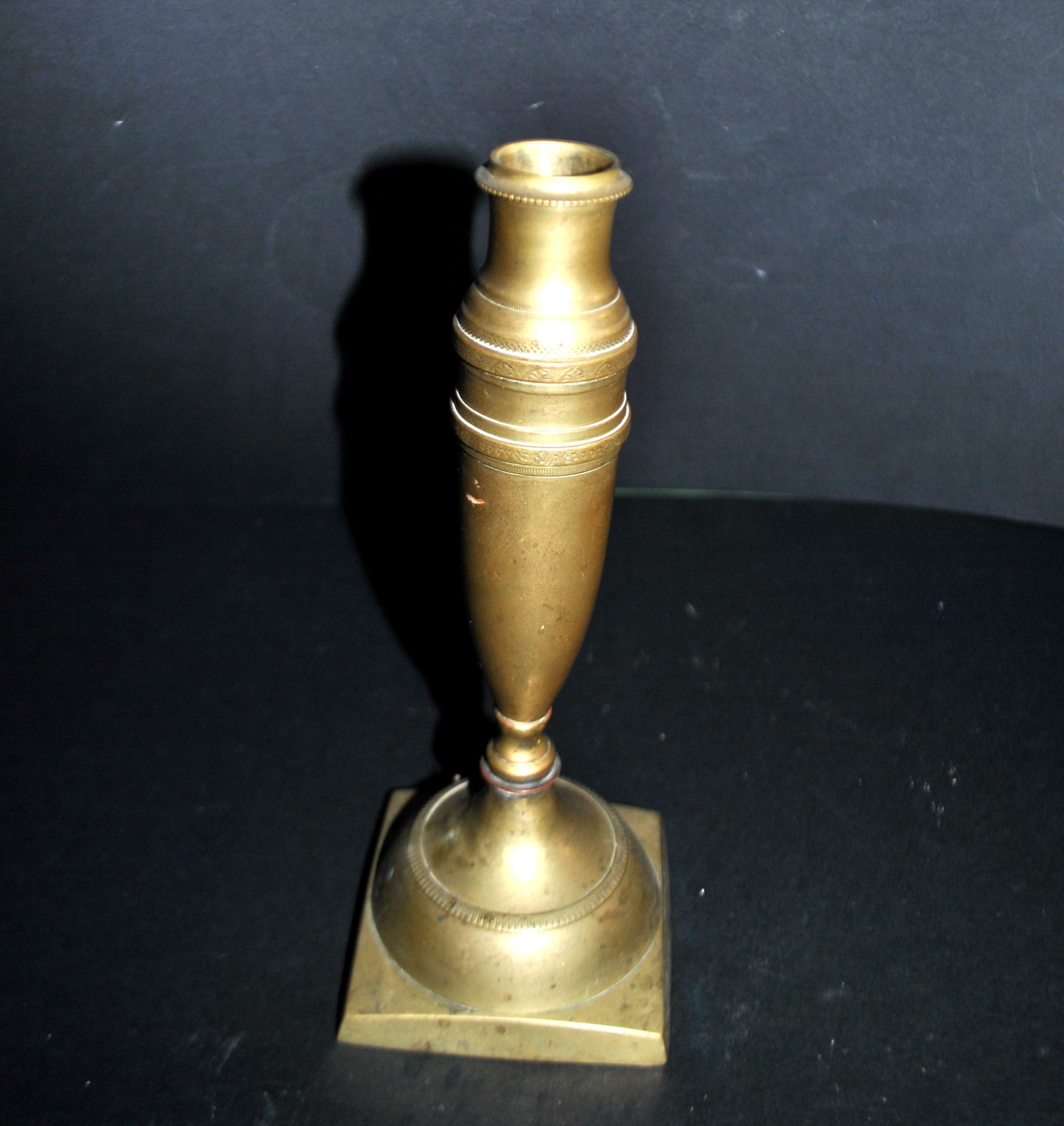 Antique baluster candlestick in bronze with hand-chiseled design.