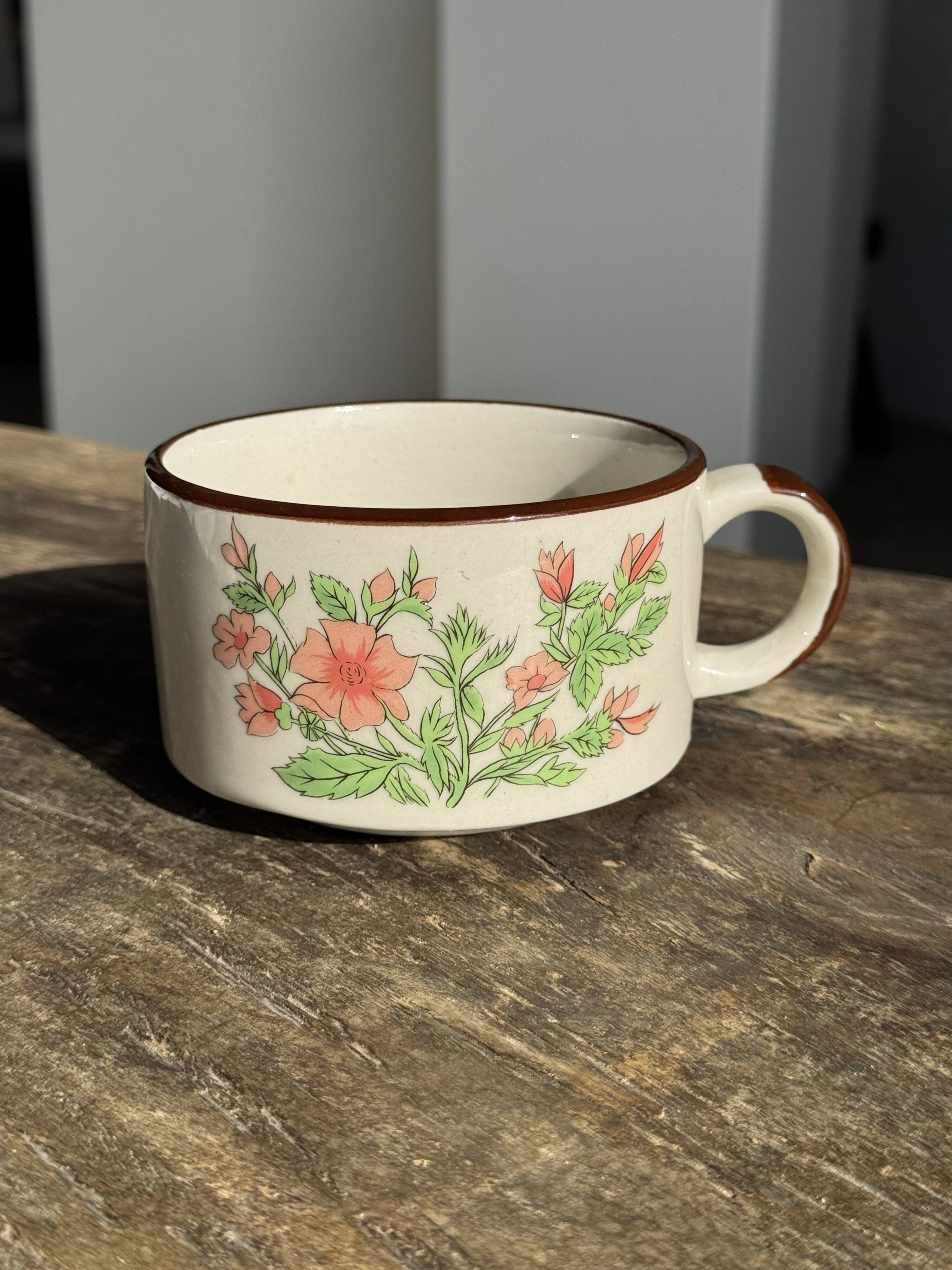 Small speckled stoneware cup made in Korea with a floral pattern H7 D11
