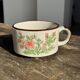 Small speckled stoneware cup made in Korea with a floral pattern H7 D11