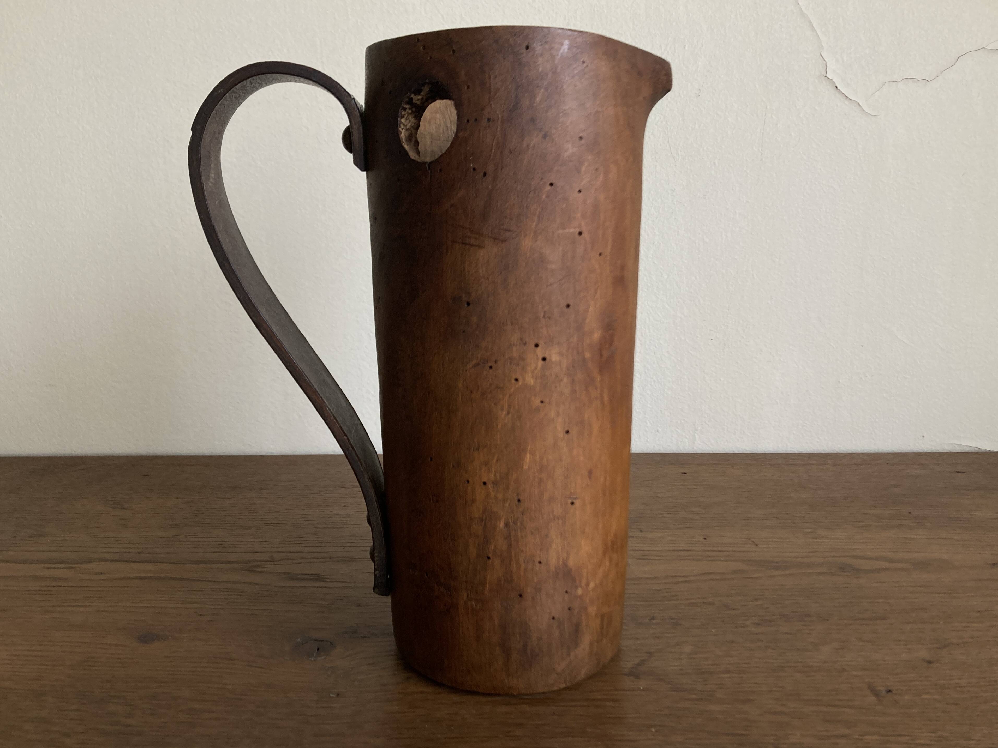 Mountain pitcher in monoxile wood and leather folk art