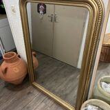 Antique gilded mirror in old Louis Philippe wood