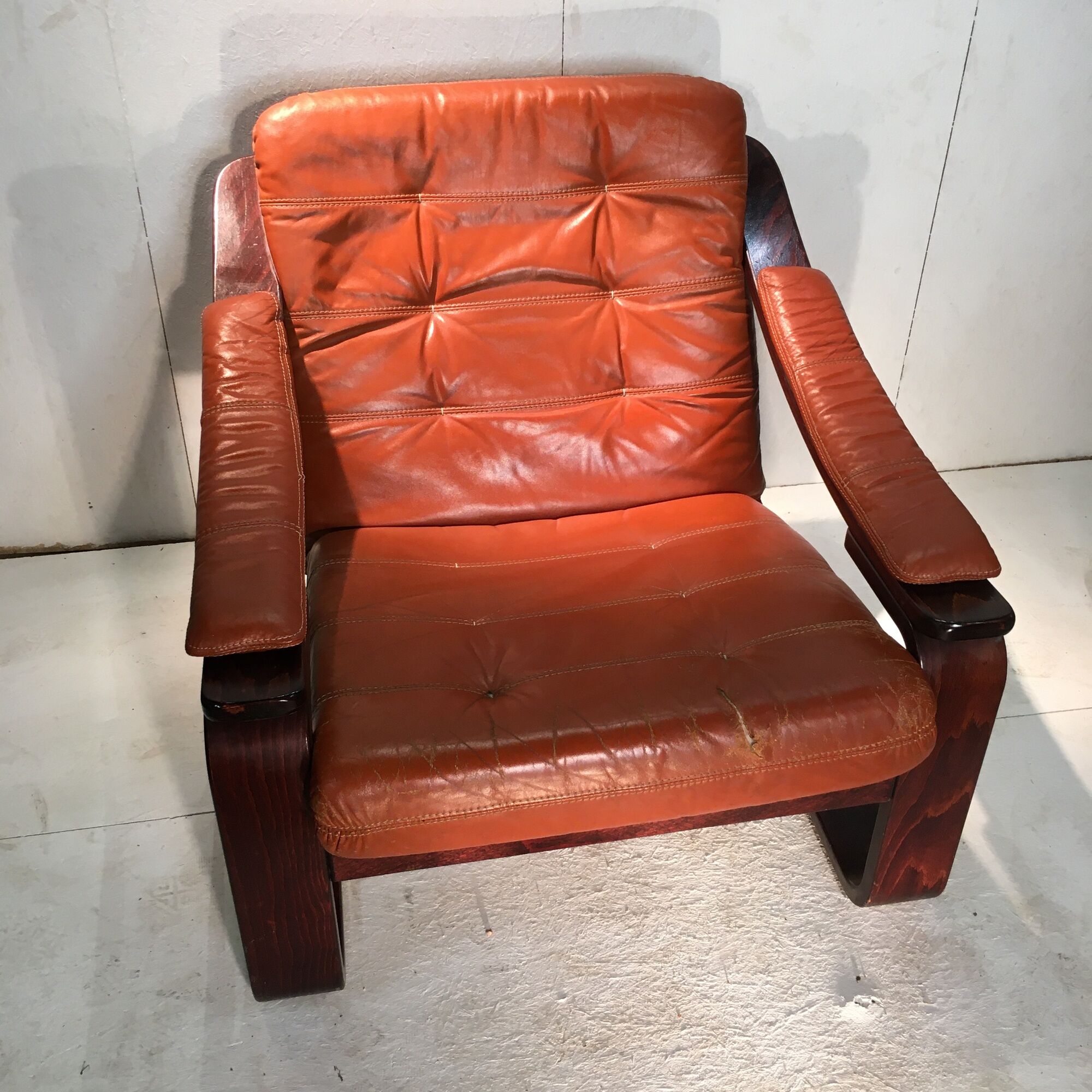 Duo of ochre leather and wood frame armchairs