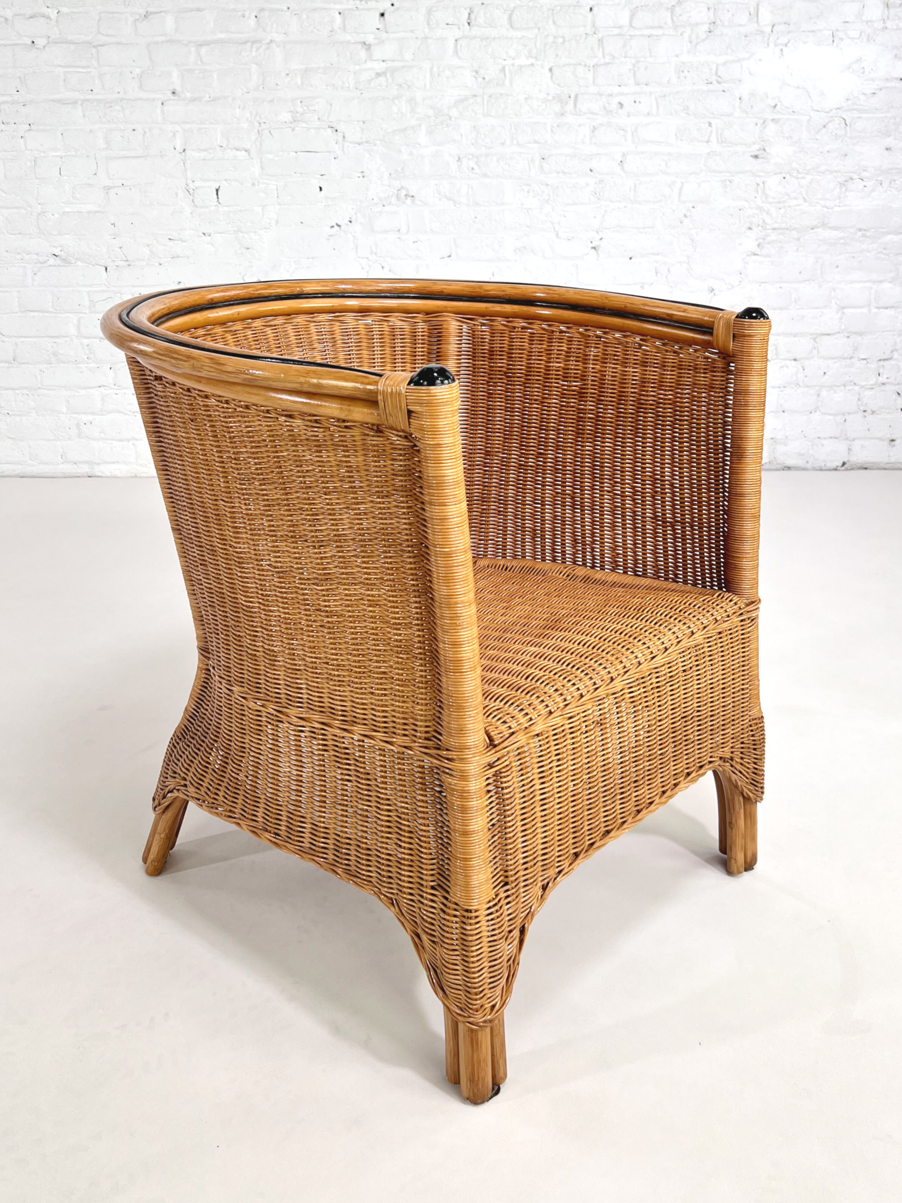 Pair of cabriolet armchairs in wicker and black edging