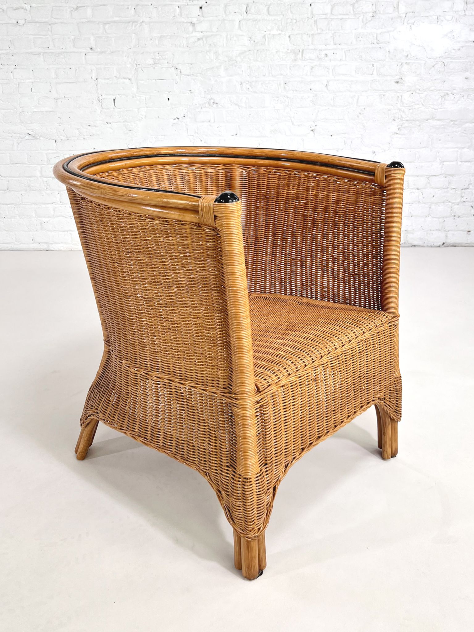 Pair of cabriolet armchairs in wicker and black edging